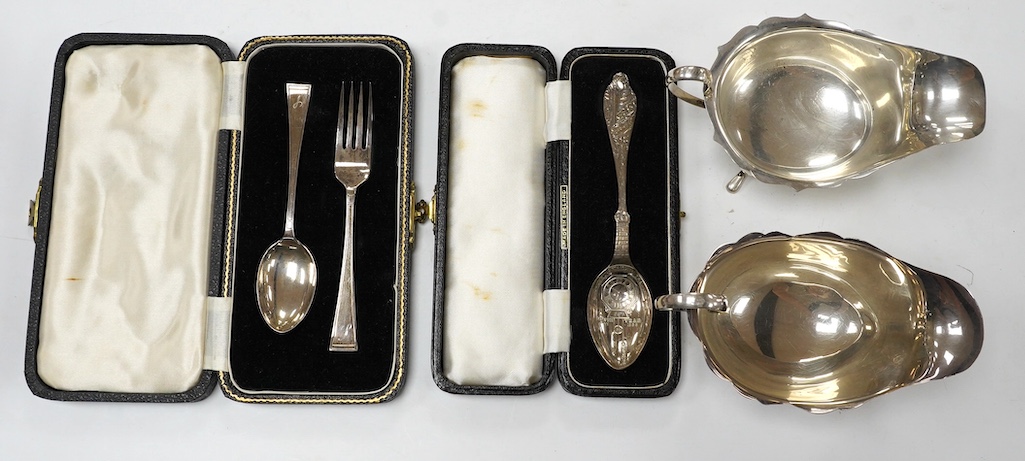 Two George V silver sauceboats and two cased flatware sets. Condition - fair